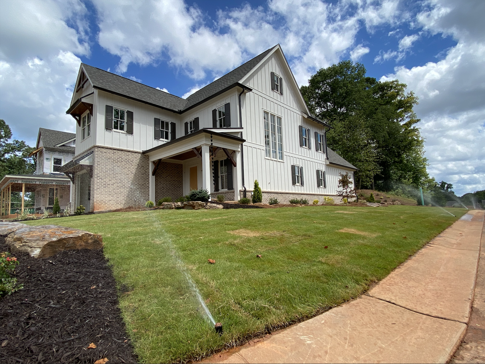 White house with lawn and landscaping