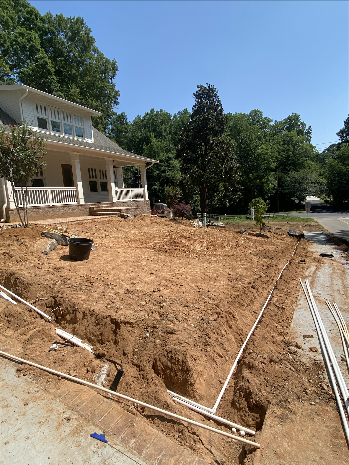 A house with a dirt yard and a house with a dirt driveway in a rural setting